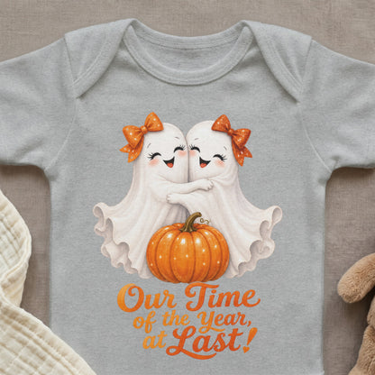 Two ghosts hug over a pumpkin with text "Our Time of the Year, at Last!".