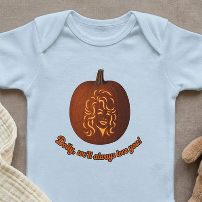 Light blue baby onesie with a pumpkin carved with Dolly Parton's face and text.