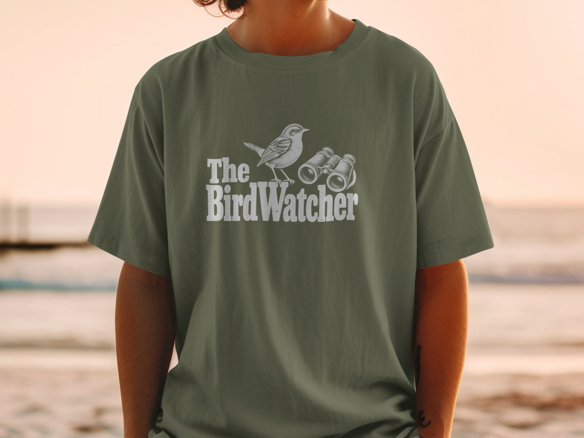 Green t-shirt with white graphic of a bird and binoculars, reads "The BirdWatcher."