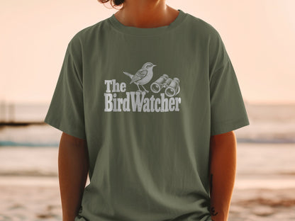 Green t-shirt with white graphic of a bird and binoculars, reads "The BirdWatcher."