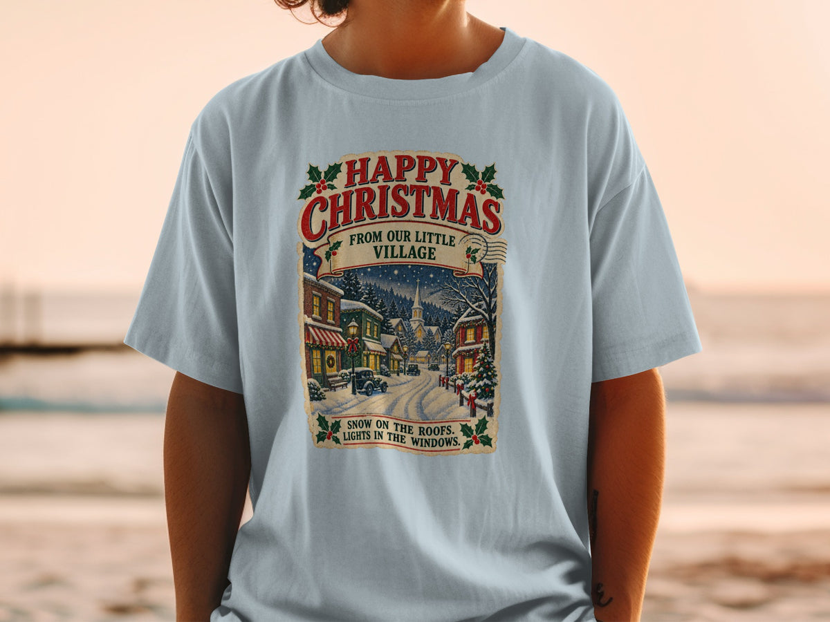 T-shirt with vintage Christmas village scene and text.