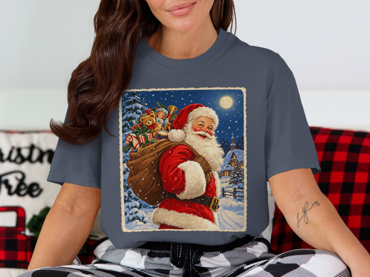 Santa Claus carrying a sack of toys through a snowy village at night.