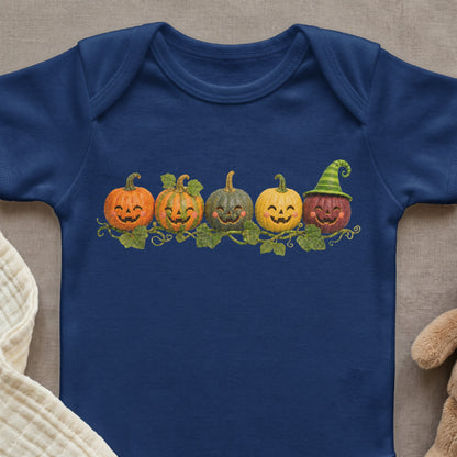 Navy blue baby onesie with a row of smiling cartoon pumpkins and vines.