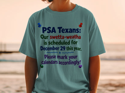 Teal t-shirt with text "PSA Texans: Our swetta-weatha is scheduled for December 29 this year. Please mark your calendars accordingly!"