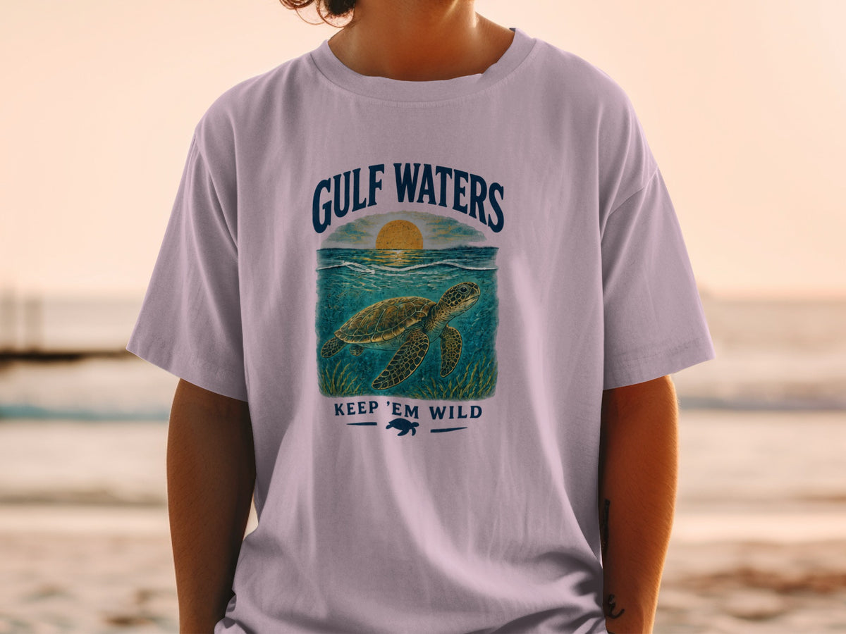 Light purple t-shirt with "Gulf Waters Keep 'Em Wild" text and sea turtle graphic.