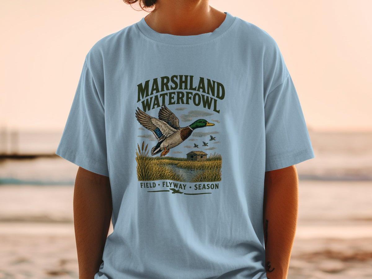 Light blue t-shirt with "Marshland Waterfowl" graphic featuring a flying duck.