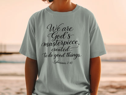 Grey t-shirt with black text: "We are God's masterpiece, created... to do good things. -Ephesians 2:10"