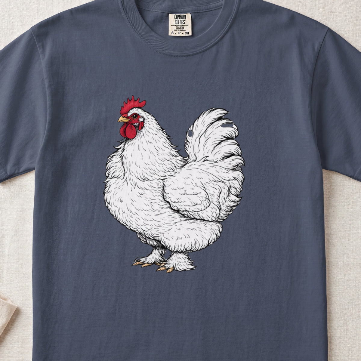 A dark blue crewneck t-shirt featuring a detailed illustration of a white rooster centered on the chest.