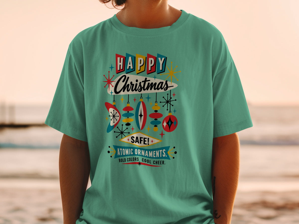 Teal t-shirt with "Happy Christmas" in retro style and atomic ornaments.