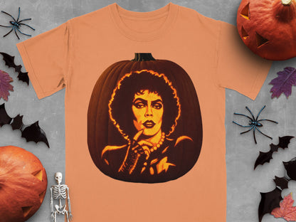 An orange t-shirt displays a carved pumpkin graphic featuring a face with a large afro hairstyle.