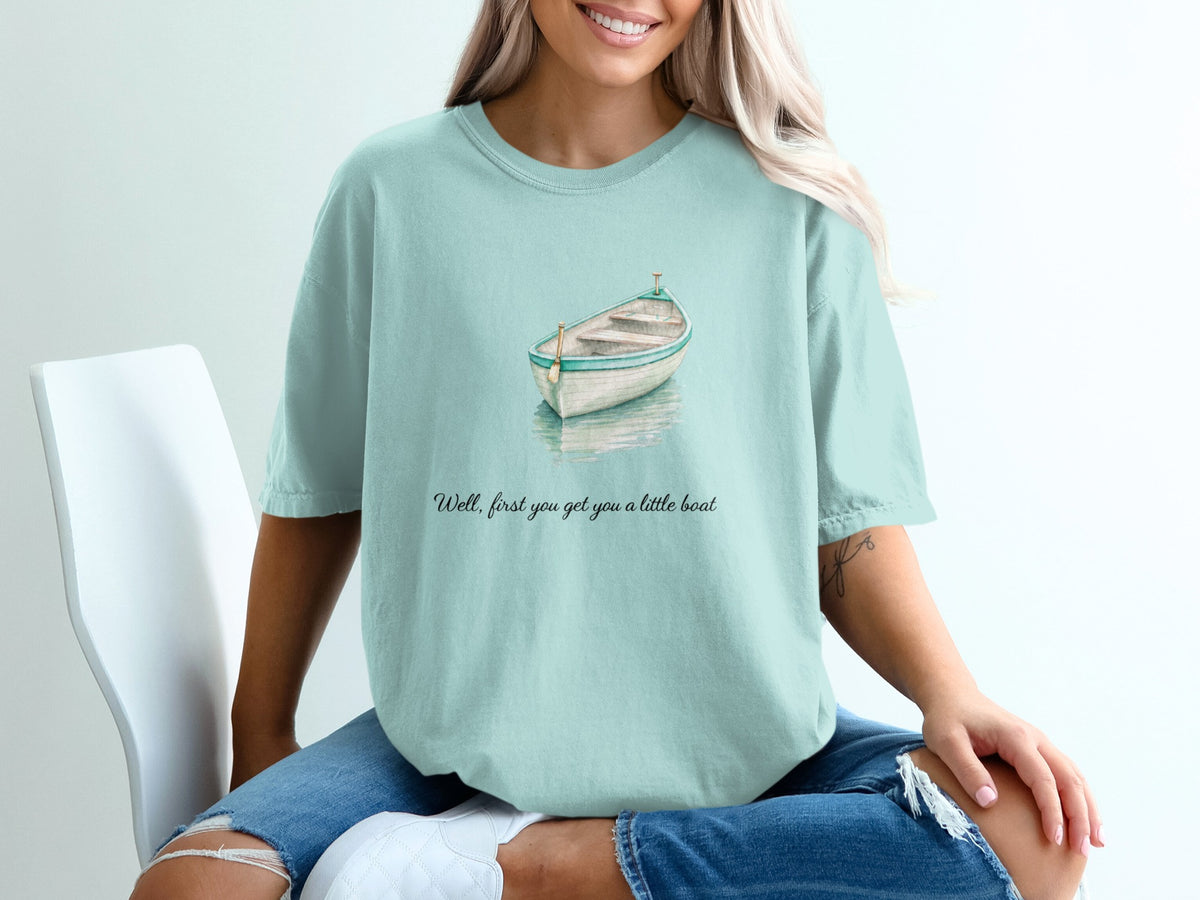 Mint t-shirt with watercolor boat graphic and text "Well, first you get you a little boat".