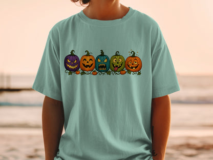 T-shirt with a Halloween graphic of five grinning, carved pumpkins on vines.