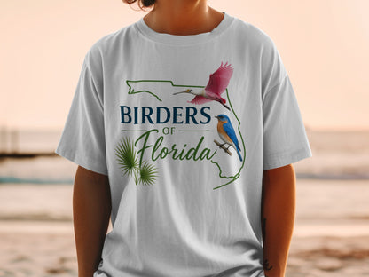 White t-shirt graphic with "Birders of Florida" text, palm fronds, and two birds.