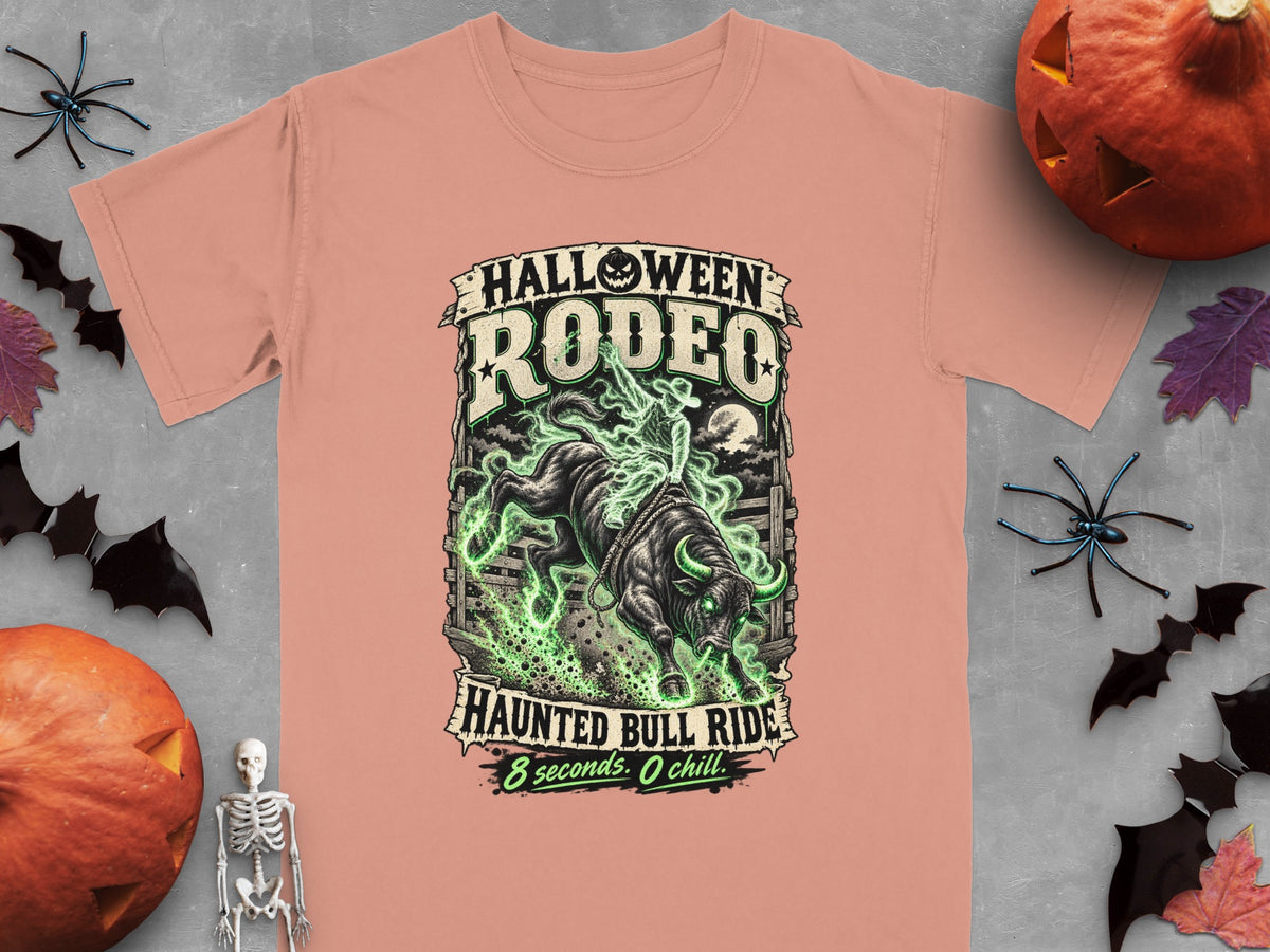 Halloween Rodeo Haunted Bull Ride graphic on a peach t-shirt.