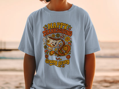 Light blue t-shirt with retro graphic: "Happy Thanksgiving Groovy Gravy" and a winking gravy boat.