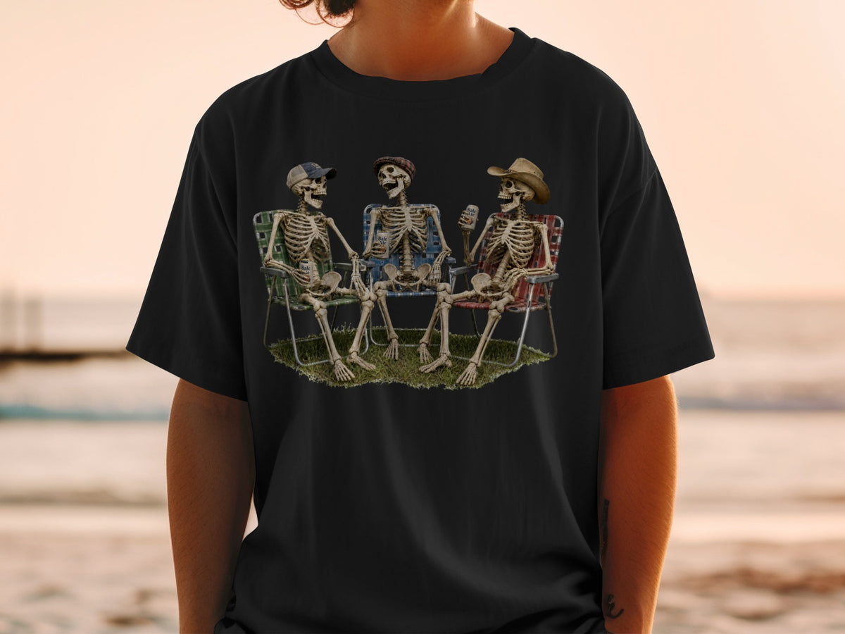 Three skeletons wearing hats relax in lawn chairs on grass, holding drinks.