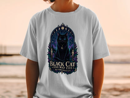 Black cat with star map eyes on a t-shirt, text reads "Black Cat Star Map Eyes Map to Halloween City".