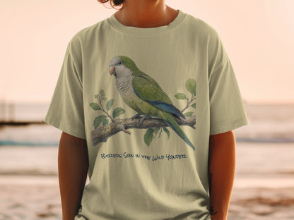 Green parrot perched on a branch with text "BIRDERs: SEEN IN THE WILD YONDER".