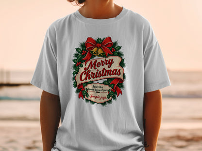 White t-shirt with a Merry Christmas wreath featuring bells and holly.