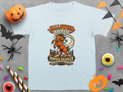 Light blue t-shirt with "Halloween Rodeo Pumpkin Wrangler" graphic and a lasso-twirling jack-o'-lantern.