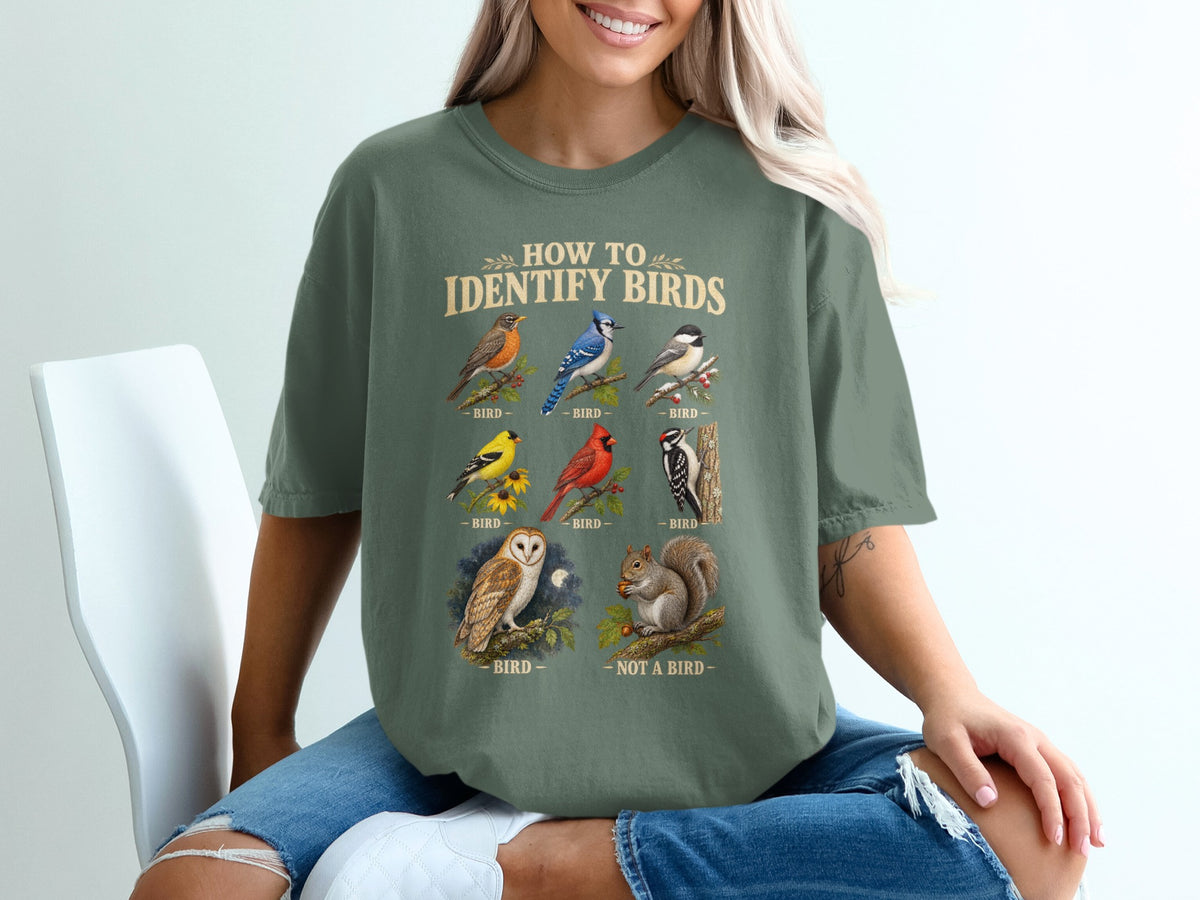 Shirt graphic: "How to Identify Birds" with robin, blue jay, chickadee, yellow finch, cardinal, woodpecker, owl, and squirrel.