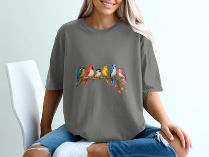 T-shirt with watercolor art of six colorful birds perched on a branch.