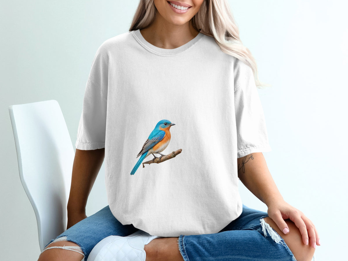 White t-shirt with a blue bird perched on a branch graphic on the chest.