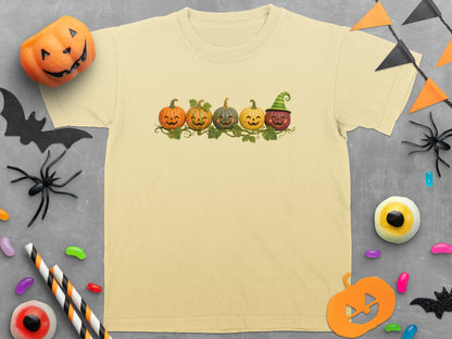 Cream t-shirt with five smiling jack-o'-lanterns on a vine print.