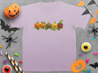 Light purple t-shirt with five smiling jack-o'-lanterns and green vines graphic.