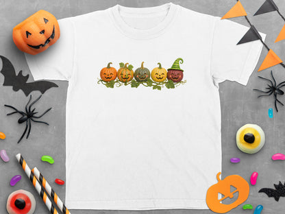 White t-shirt with five smiling cartoon pumpkins on a vine.